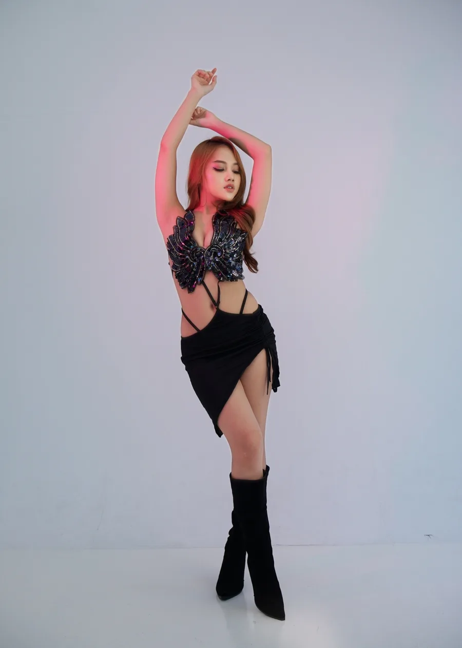 DJ Maya Lorensina – studio portrait, arms raised