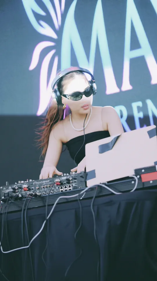 DJ Maya Lorensina dancing behind the decks